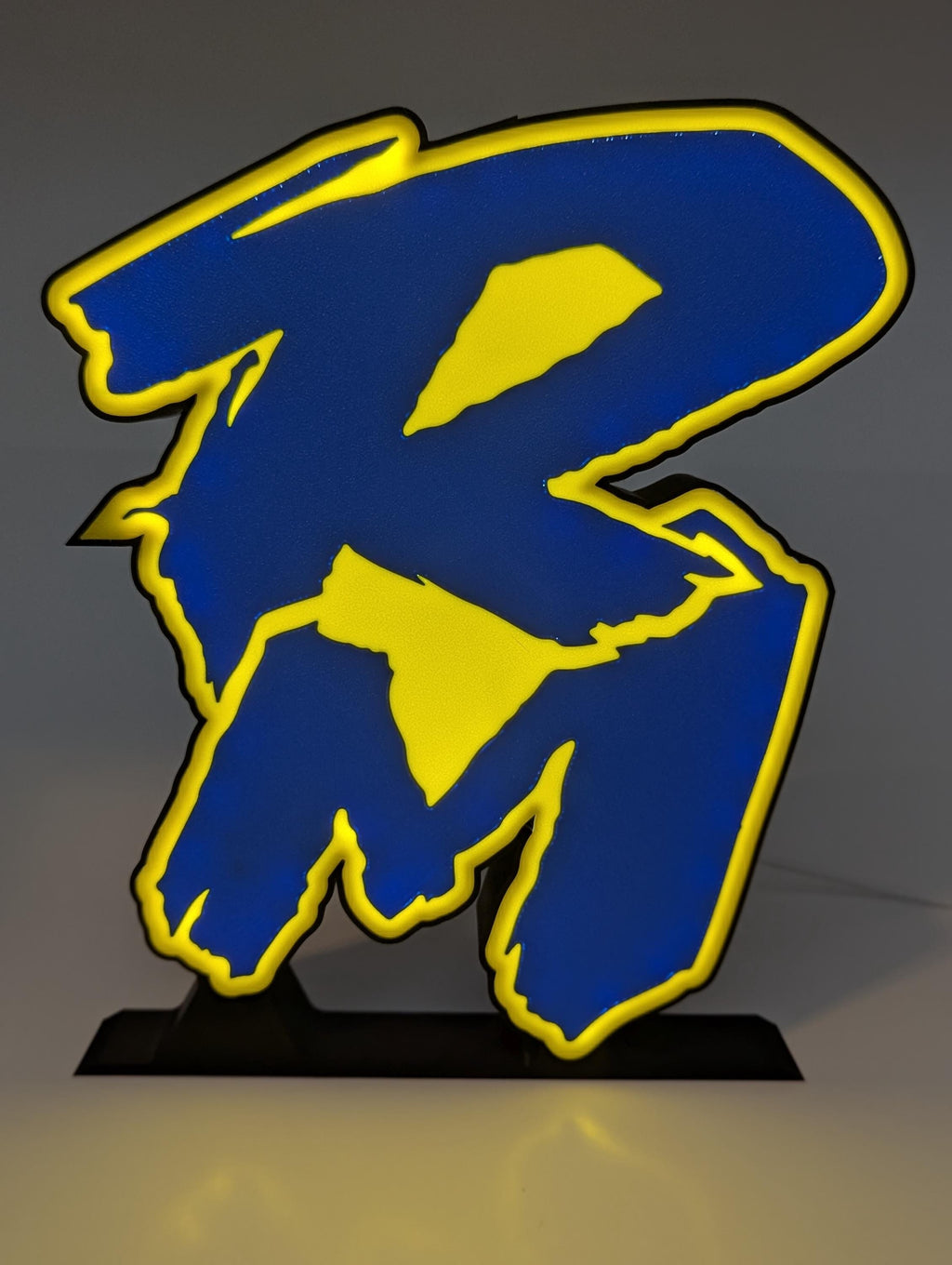 Retro Suzuki RM logo LED lightbox glowing on a desk
